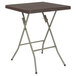 A Flash Furniture brown rattan plastic folding table with square legs.