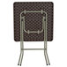 The back of a Flash Furniture brown plastic rattan folding table.