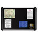 A black MasterVision fabric bulletin board with a silver frame holding maps and information.