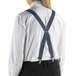 A person wearing dark grey Henry Segal clip-end suspenders over a white shirt and black pants.