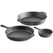 A group of three Valor pre-seasoned cast iron skillets of different sizes.