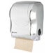 A San Jamar stainless steel look paper towel dispenser with a roll of paper.