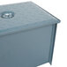 A close up of a blue metal Watts grease trap box with a lid.