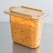 A Carlisle amber plastic lid on a container of shredded cheese.