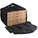 A black Cambro Insulated Pizza Delivery GoBag holding a stack of pizza boxes.