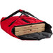 A red Cambro insulated pizza delivery bag holding two pizza boxes with red and black text.