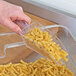 A hand using a Choice clear plastic utility scoop to serve pasta.
