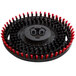 A circular black and red Minuteman pad driver with red bristles.