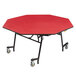 A red octagonal table with a red surface and chrome legs.