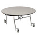 A round National Public Seating cafeteria table with a black edge and wheels.