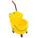 A yellow Rubbermaid WaveBrake mop bucket with black handles.