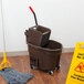 A Rubbermaid brown mop bucket with a side wringer.