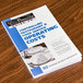 A book titled "Controlling Restaurant & Food Service Operating Costs" on a table.