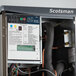 A Scotsman Prodigy Plus ice machine and dispenser with a control panel.