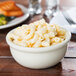 A bowl of macaroni and cheese in a white Hall China bowl.