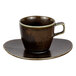 A brown Bon Chef Tavola Eros tea cup and saucer on a table.