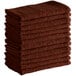 A stack of brown Choice textured terry bar towels.