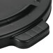 A close-up of a black Rubbermaid lid with text reading "Rubbermaid"