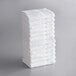 A stack of Lavex white cotton hand towels.