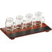 An Acopa wood tray with mini drinking jars on a table.