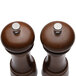 A Chef Specialties walnut salt mill and pepper mill set on a table.