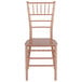 A Flash Furniture rose gold resin chiavari chair with a wooden seat.