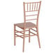 A Flash Furniture Rose Gold Resin Chiavari chair with a cushion on a white background.