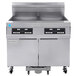 A large stainless steel Frymaster gas floor fryer with two drawers and two burners.