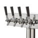 A stainless steel Avantco beer tap tower with four taps.