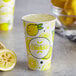 A Carnival King lemonade cup with lemonade and lemons on it.