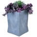 A gunmetal grey square planter with green and purple plants.