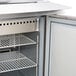 A Beverage-Air stainless steel refrigerator with a door open over a counter.