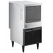A large silver and black Hoshizaki undercounter ice machine with a stainless steel top.