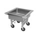 An Advance Tabco stainless steel sink with wheels.