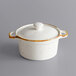 An Acopa Keystone white stoneware mini casserole dish with a white lid.