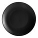 An Acopa matte black stoneware coupe plate.