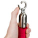 A hand holding a red Aarco stanchion rope with metal ends.
