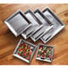 An American Metalcraft square stainless steel tray with salad on it.
