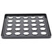 A black Cambro tray with holes in it.