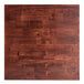 A close up of a mahogany wood butcher block table top.