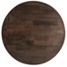 A dark brown round wooden table top on a cast iron base.