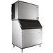 A large silver and black Manitowoc air cooled ice machine.