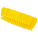 A yellow Carlisle Sparta floor scrub brush with end bristles.