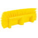A close-up of a Carlisle yellow floor scrub brush with bristles on the end.