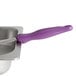 A Vollrath Jacob's Pride Purple Spoodle with a purple handle on a silver tray.