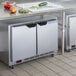 A stainless steel Beverage-Air undercounter refrigerator with fruits and vegetables on a counter.