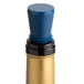 A close-up of a bottle of champagne with a dark blue Franmara Flex Seal wine stopper.