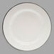 A Tablecraft enamelware plate with a black rim and cream white center.