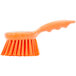An orange Carlisle Sparta pot scrub brush with a handle.