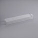 A clear plastic rectangular container with a long white rectangular handle.